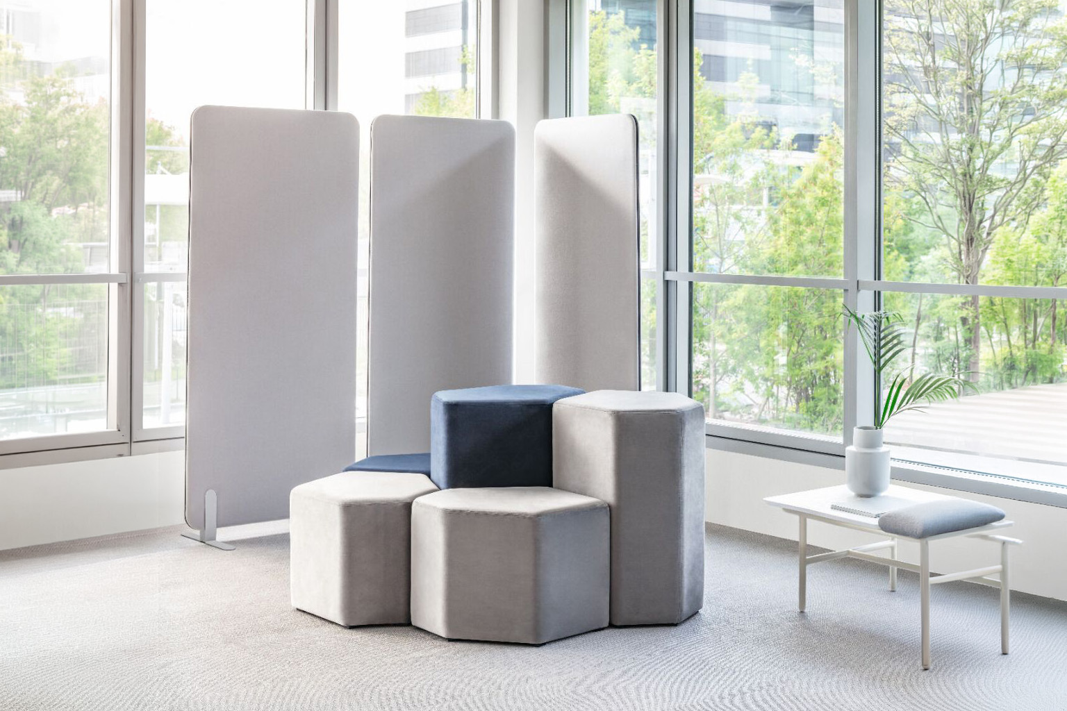 Freestanding acoustic panels creating a quieter office seating area
