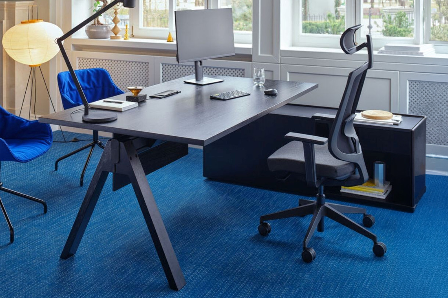 Executive office with a dark desk, task chair and visitor seating