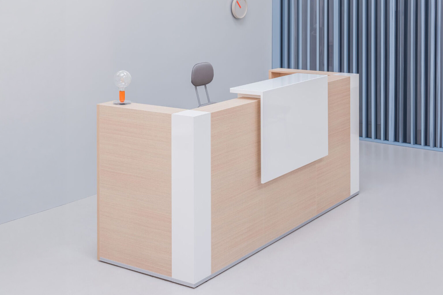 Compact reception desk with light wood and white panels