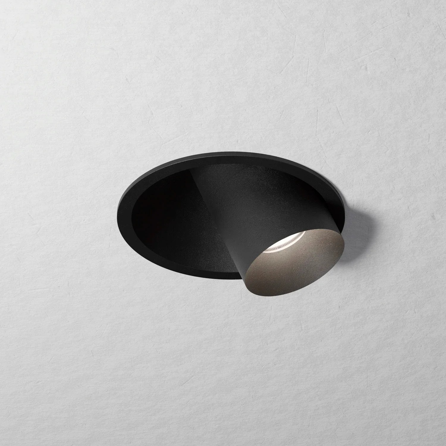 HER recessed light fitting on a pale ceiling surface